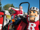 President Barchi sitting on a tractor with the Scarlet Knight at the 2017 Fall Family Festival